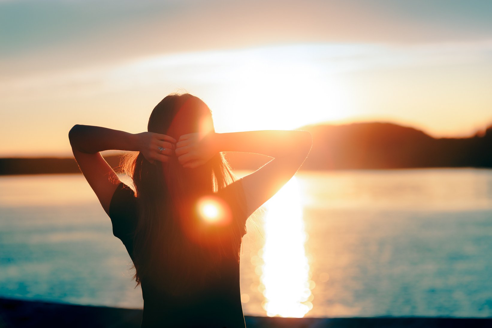 Happy Hopeful Woman Looking at the Sunset by the Sea